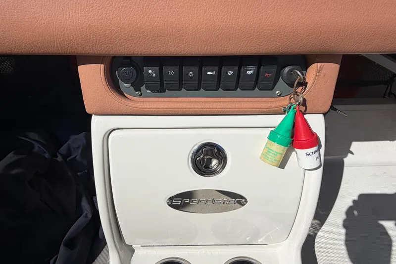 Slide: The Image of 2006 Chris-Craft Speedster dashboard with key ignition and control switches. - 23