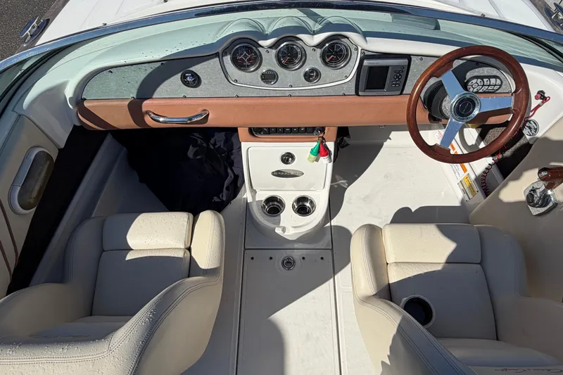 Slide: The Image of 2006 Chris-Craft Speedster boat interior with classic dashboard and leather seats. - 24
