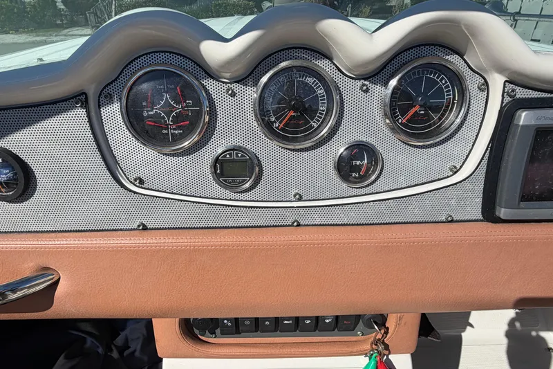 Slide: The Image of Dashboard of a 2006 Chris-Craft Speedster boat with classic gauges and controls. - 25