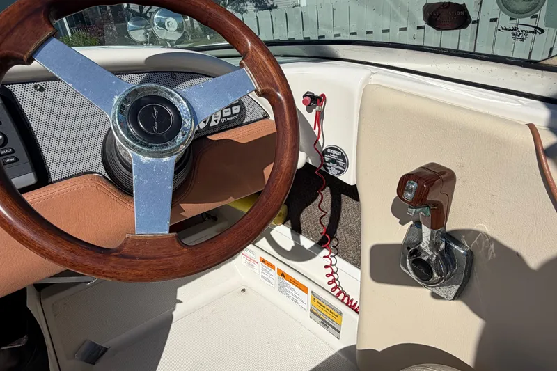 Slide: The Image of 2006 Chris-Craft Speedster dashboard with wooden steering wheel and control panel. - 28