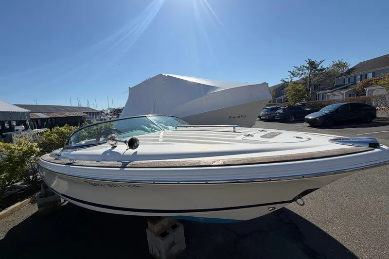 Slide: The Image of 2006 Chris-Craft Speedster boat on display in a sunny marina setting. - 3