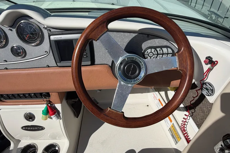 Slide: The Image of 2006 Chris-Craft Speedster dashboard with wooden steering wheel and instrument panel. - 30