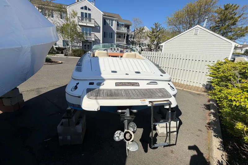Slide: The Image of 2006 Chris-Craft Speedster boat on blocks, parked near residential buildings. - 7