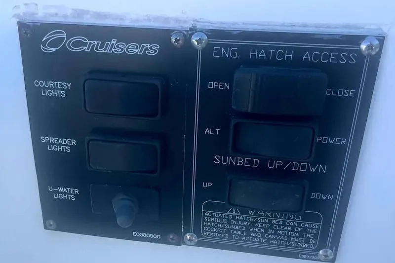 Slide: The Image of Control panel on a 2014 Cruisers Yachts 380 Express, featuring light and hatch switches. - 10