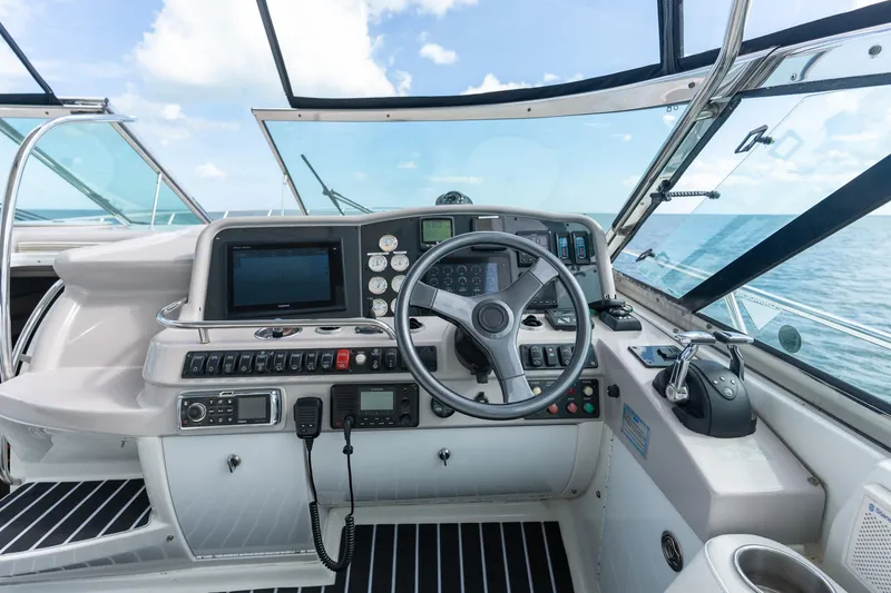 Slide: The Image of Cockpit of 2005 Formula 48 Yacht with steering wheel and navigation controls. - 25