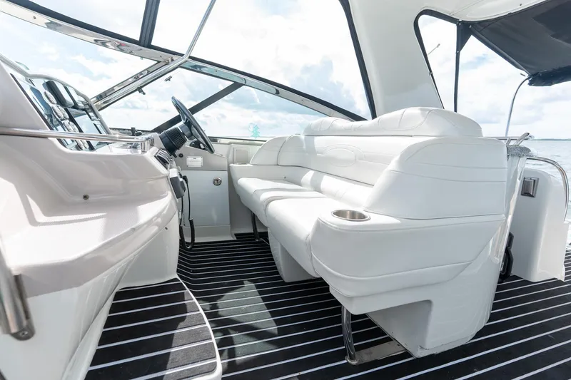 Slide: The Image of Interior of 2005 Formula 48 Yacht with white seating and modern dashboard. - 27