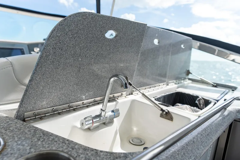 Slide: The Image of Luxury 2005 Formula 48 Yacht sink area with granite countertop and ocean view. - 35