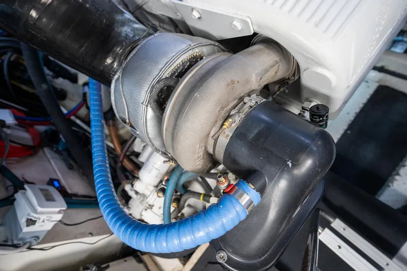 Slide: The Image of Engine component of a 2005 Formula 48 Yacht, featuring hoses and mechanical parts. - 39