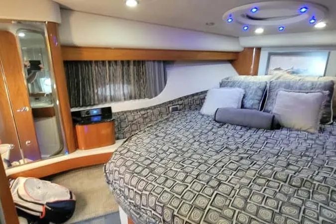Slide: The Image of Luxurious interior of a 2005 Formula 48 Yacht with plush bedding and modern lighting. - 49