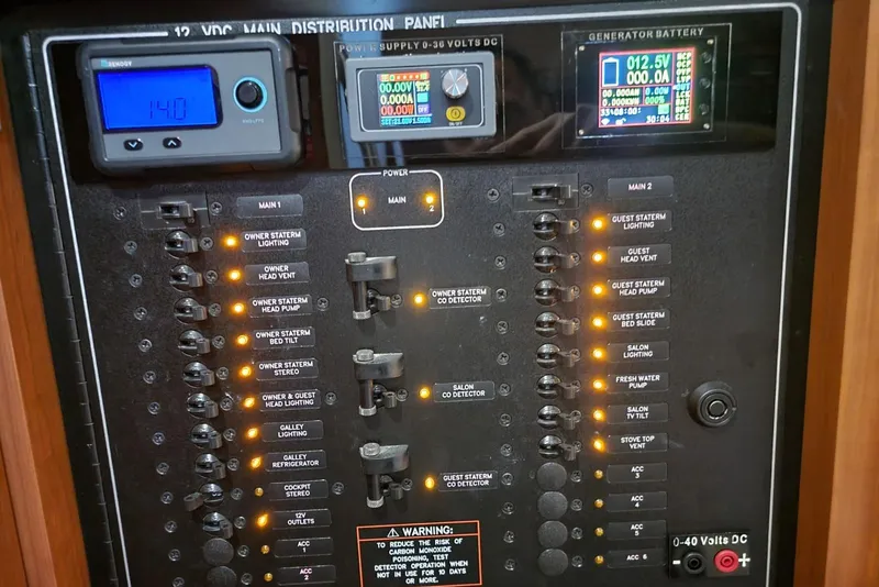 Slide: The Image of Electrical control panel of a 2005 Formula 48 Yacht with illuminated switches and digital displays. - 58