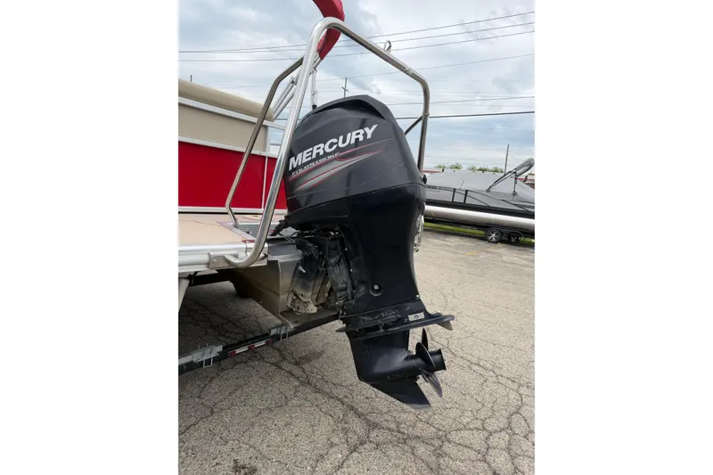 Slide: The Image of 2014 Bennington 21 SLX with Mercury outboard motor, parked on pavement. - 11