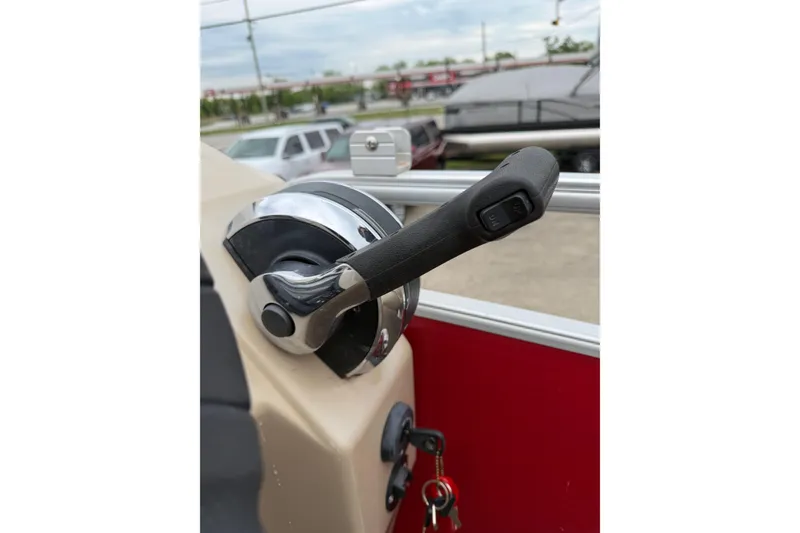 Slide: The Image of Throttle control lever on a 2014 Bennington 21 SLX boat, with key ignition visible. - 13