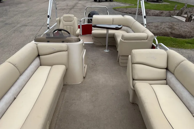Slide: The Image of 2014 Bennington 21 SLX pontoon boat with beige seating and a central table. - 3