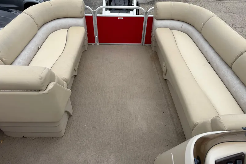 Slide: The Image of 2014 Bennington 21 SLX pontoon boat interior with beige seating and red panel. - 4