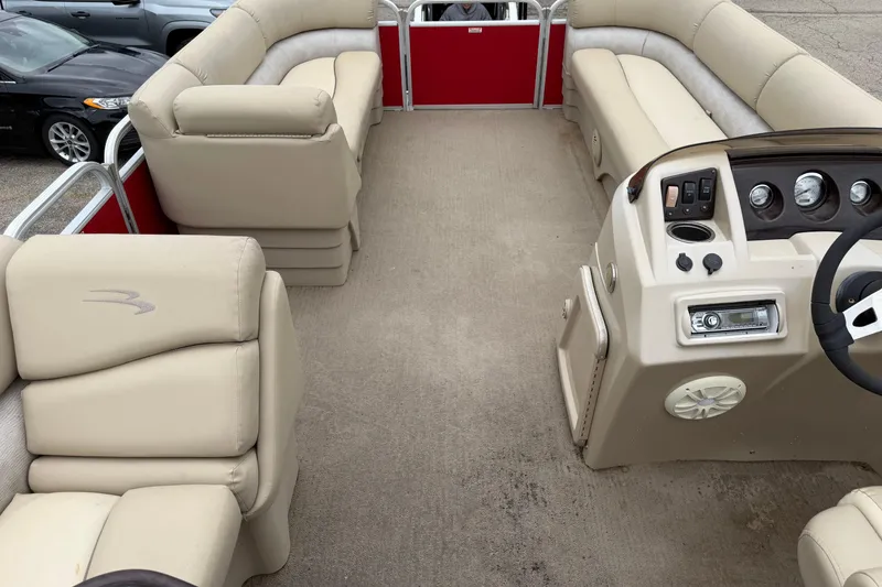 Slide: The Image of 2014 Bennington 21 SLX pontoon boat interior with beige seating and control panel. - 6