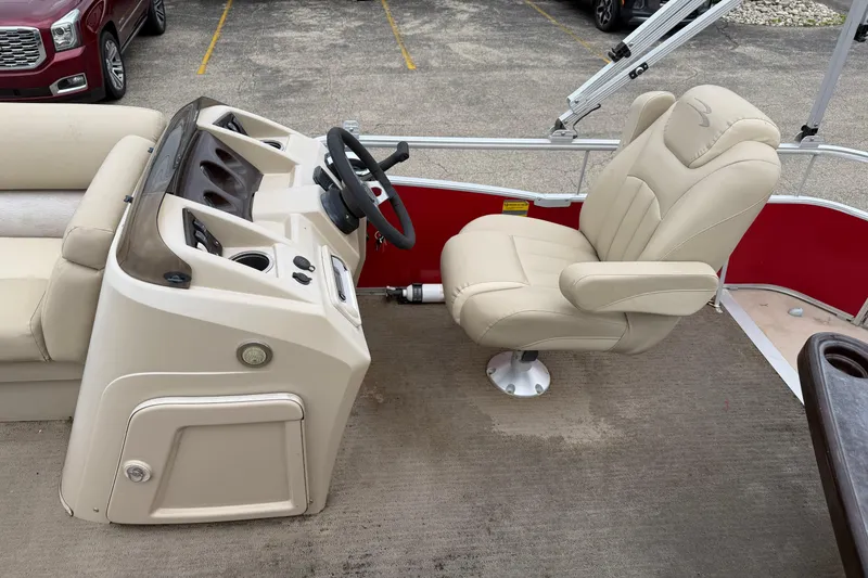 Slide: The Image of 2014 Bennington 21 SLX boat interior with beige captain's chair and steering console. - 9