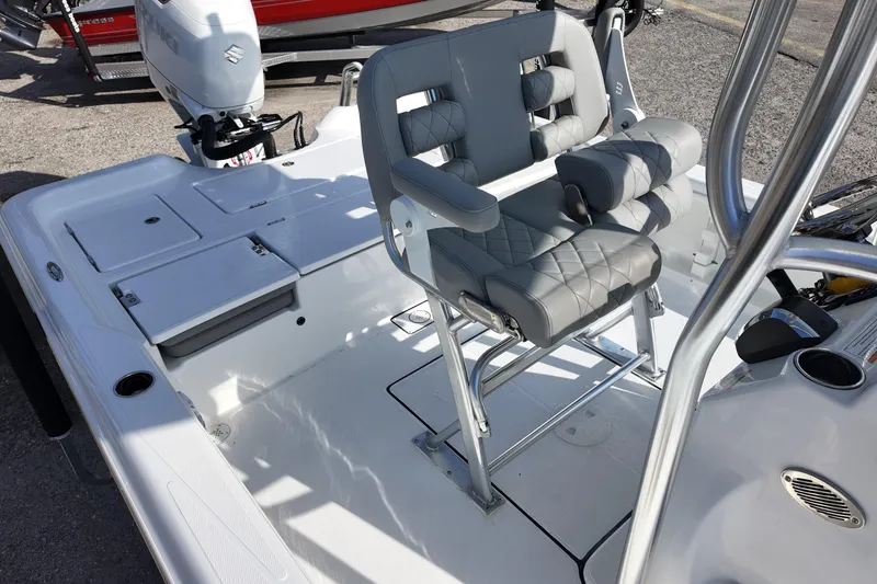 Slide: The Image of 2026 Blazer PureBay 2400 boat interior with cushioned seating and outboard motor. - 11