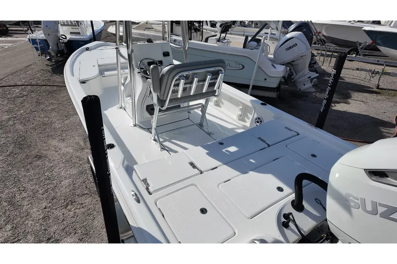 Slide: The Image of 2026 Blazer PureBay 2400 boat with Suzuki engine, docked outdoors. - 4