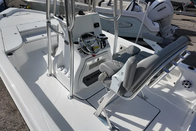 Slide: The Image of 2026 Blazer PureBay 2400 boat interior with steering console and seating. - 5