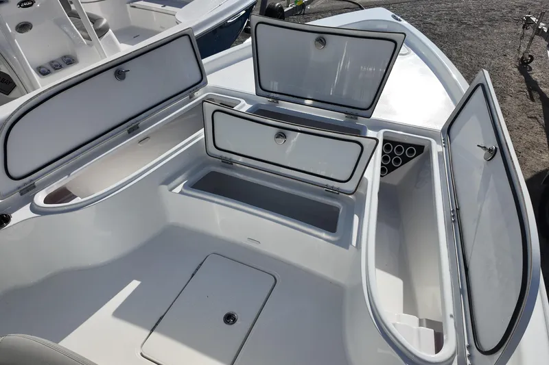 Slide: The Image of 2026 Blazer PureBay 2400 boat storage compartments open, showcasing spacious interior design. - 9