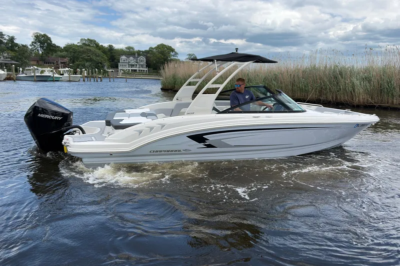 The Image of 2026 Chaparral 23 SSi OB boat cruising on a scenic waterway. - 0