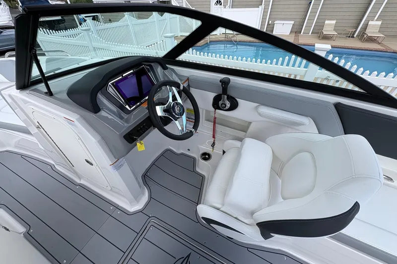Slide: The Image of 2026 Chaparral 23 SSi OB boat interior with modern dashboard and comfortable seating. - 13