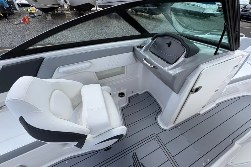Slide: The Image of Interior view of 2026 Chaparral 23 SSi OB boat, featuring sleek seating and modern dashboard. - 14