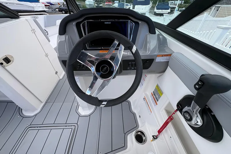 Slide: The Image of 2026 Chaparral 23 SSi OB boat cockpit with steering wheel and control panel. - 15
