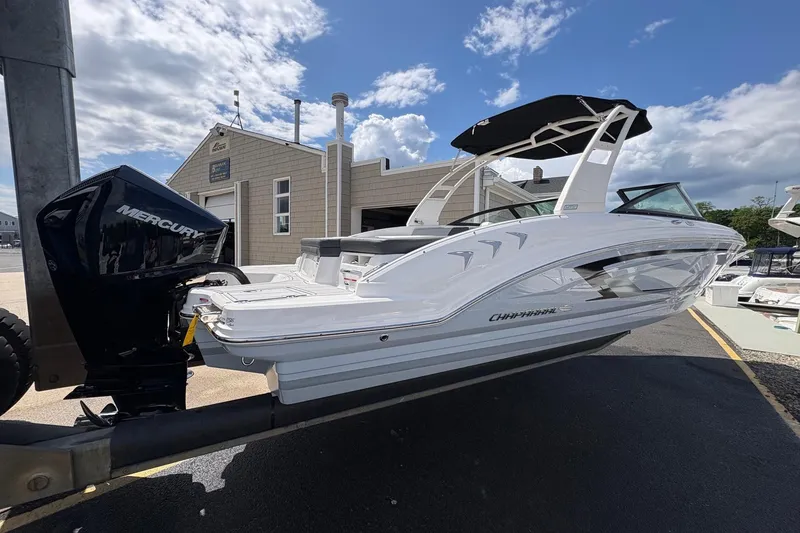 Slide: The Image of 2026 Chaparral 23 SSi OB boat with Mercury outboard engine, docked under a blue sky. - 19