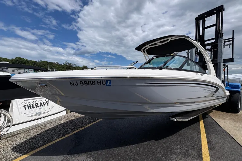 Slide: The Image of 2026 Chaparral 23 SSi OB boat on trailer under cloudy sky. - 21