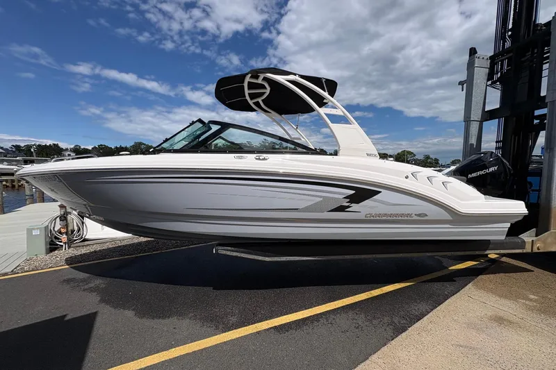 Slide: The Image of 2026 Chaparral 23 SSi OB boat on dock under clear sky. - 23