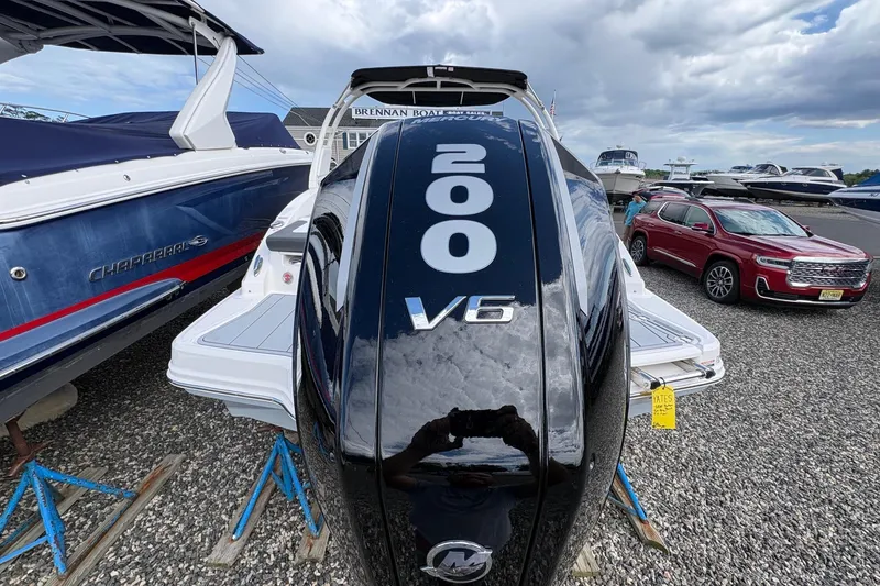 Slide: The Image of Chaparral 23 SSi OB 2026 boat with V6 engine displayed outdoors. - 24