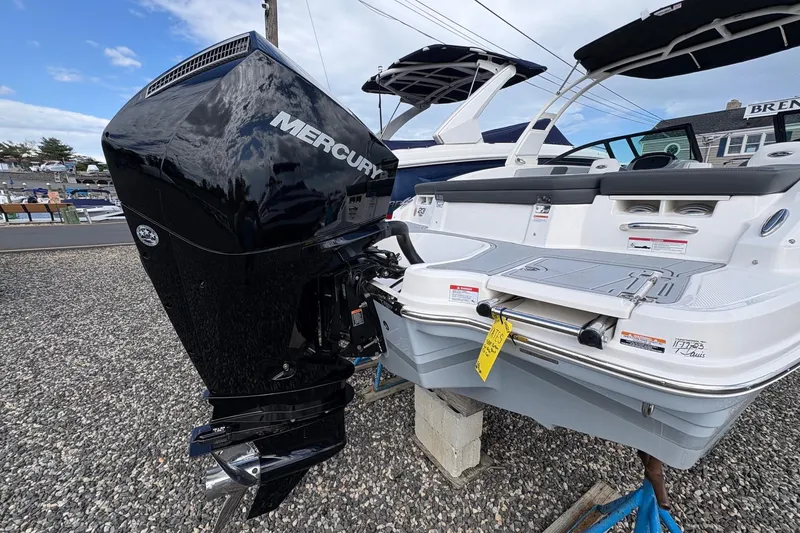 Slide: The Image of 2026 Chaparral 23 SSi OB boat with Mercury outboard motor, displayed outdoors. - 26