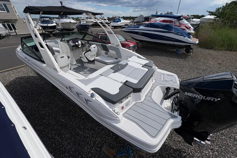 Slide: The Image of 2026 Chaparral 23 SSi OB boat with Mercury outboard engine, docked in a marina. - 27