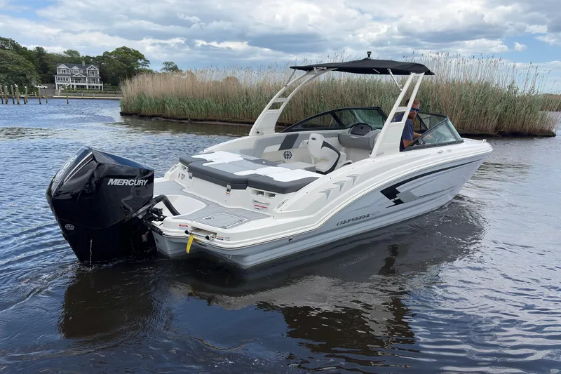 Slide: The Image of 2026 Chaparral 23 SSi OB boat with Mercury outboard engine on calm water. - 3