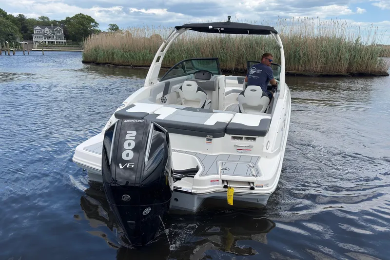 Slide: The Image of 2026 Chaparral 23 SSi OB boat with Mercury 200 V6 engine on a serene lake. - 4