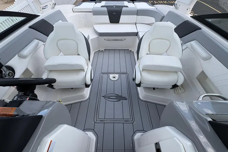 Slide: The Image of Interior of 2026 Chaparral 23 SSi OB boat with white seating and sleek design. - 9