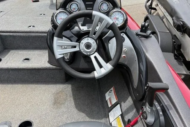 Slide: The Image of 2023 Tracker Pro Team 195 TXW Tournament Edition boat dashboard with steering wheel and gauges. - 19