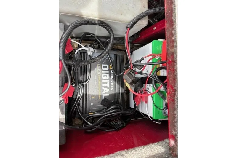 Slide: The Image of 2023 Tracker Pro Team 195 TXW Tournament Edition boat battery compartment with Minn Kota digital charger. - 21