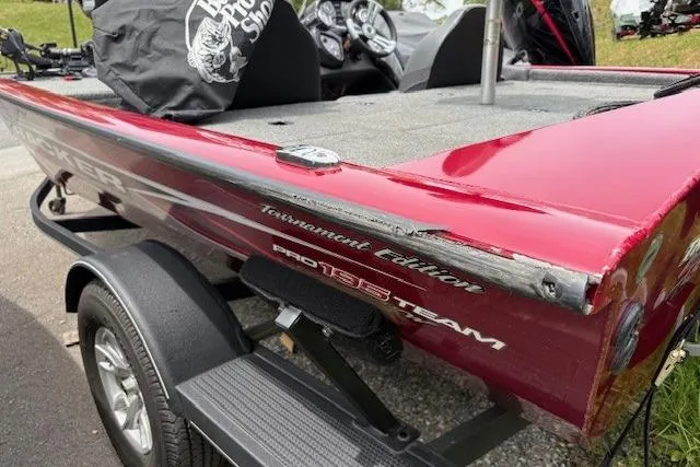 Slide: The Image of 2023 Tracker Pro Team 195 TXW Tournament Edition boat, red exterior, on trailer. - 25