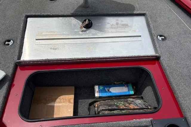 Slide: The Image of 2023 Tracker Pro Team 195 TXW Tournament Edition boat storage compartment with items inside. - 5