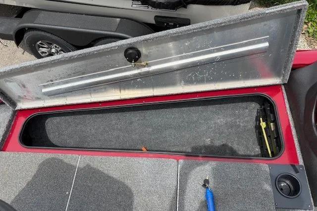 Slide: The Image of Open storage compartment on 2023 Tracker Pro Team 195 TXW Tournament Edition boat. - 7