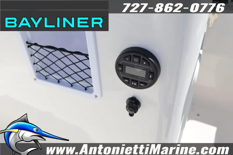 Slide: The Image of 2026 Bayliner Element E16 boat dashboard with audio controls and storage net. - 14