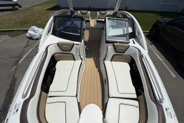 Slide: The Image of 2021 Yamaha Boats 275SD interior with white seating and wood accents. - 11