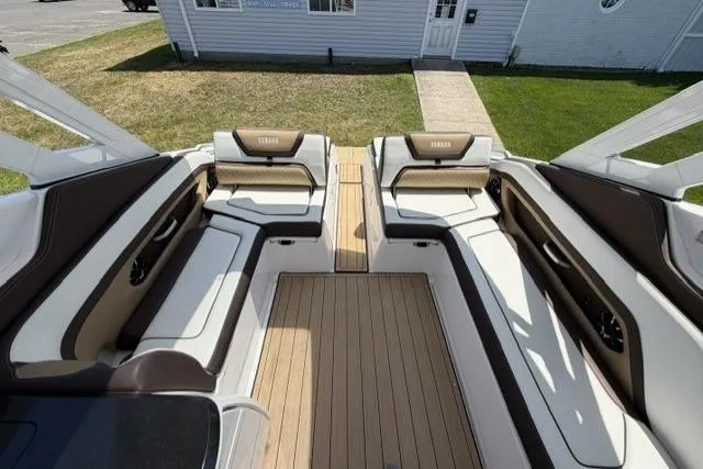 Slide: The Image of 2021 Yamaha Boats 275SD interior with luxurious seating and teak-style flooring. - 13