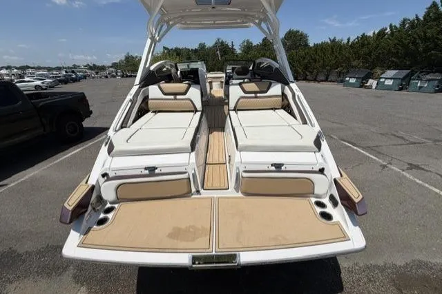 Slide: The Image of 2021 Yamaha Boats 275SD with spacious seating and sleek design in a parking lot. - 17