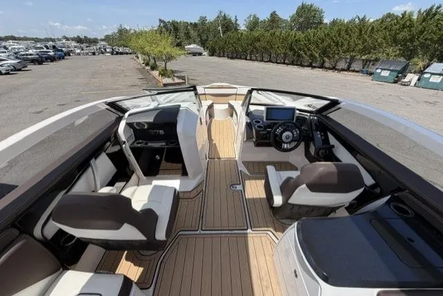 Slide: The Image of 2021 Yamaha Boats 275SD interior with sleek seating and modern dashboard design. - 18