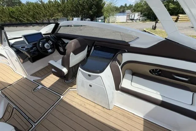 Slide: The Image of 2021 Yamaha Boats 275SD interior with sleek design, modern dashboard, and comfortable seating. - 19