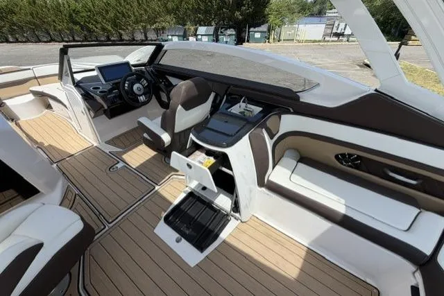 Slide: The Image of 2021 Yamaha Boats 275SD interior with modern dashboard and seating. - 24