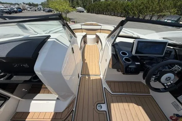Slide: The Image of 2021 Yamaha Boats 275SD interior with sleek design, modern dashboard, and spacious seating. - 25